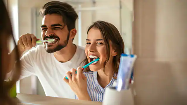 adults brushing teeth