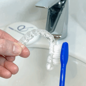 Cleaning a retainer with a toothbrush and soap