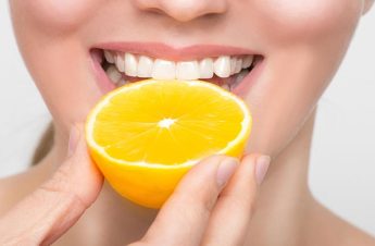 Smile with lemon beside it. Vitamins for healthy teeth.