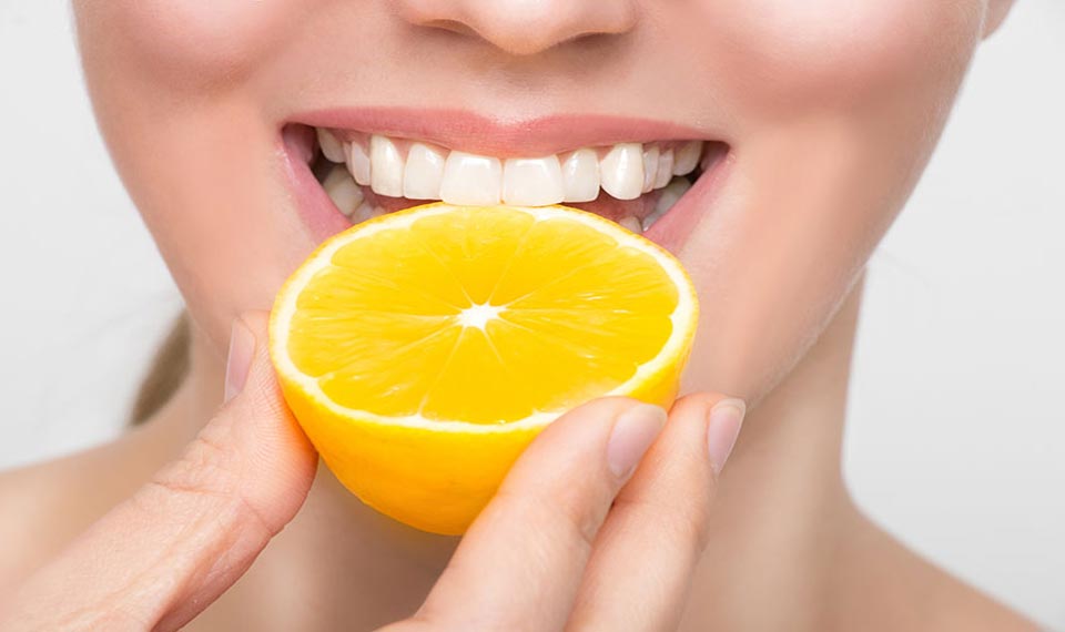 Smile with lemon beside it. Vitamins for healthy teeth.